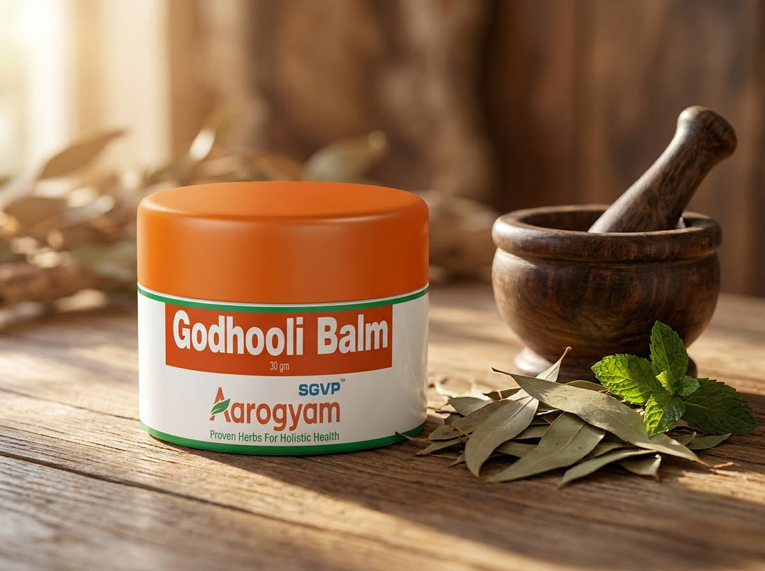 Godhooli Balm Ayurvedic pain relief balm with dried herbs and mortar pestle on wooden table